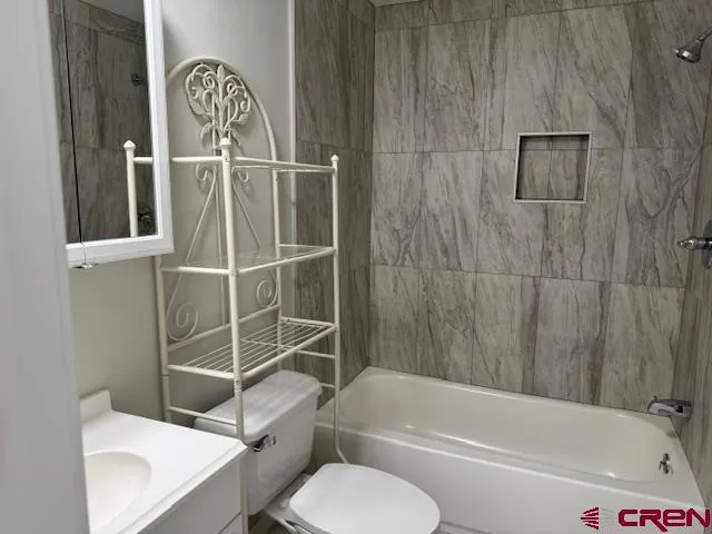 a bathroom with a toilet and a bathtub