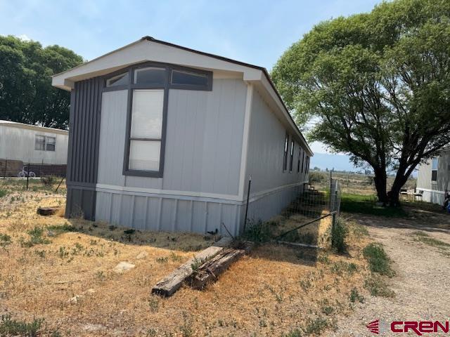 28260 Highway 160, Unit 81 Cortez, CO 81321 - Photo 3 of 20 a front view of a house with a yard