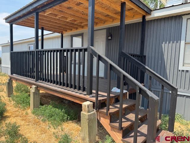 28260 Highway 160, Unit 81 Cortez, CO 81321 - Photo 4 of 20 a view of balcony with wooden floor and fence