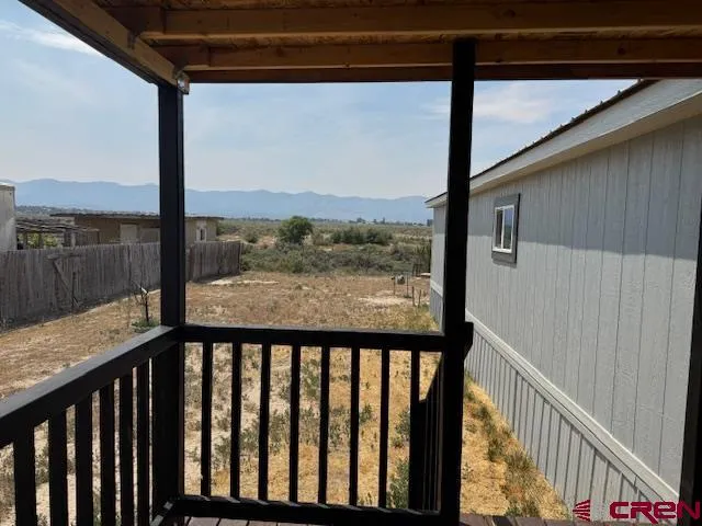 a view of a balcony with a floor to ceiling window and an outdoor view