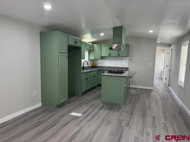 a kitchen with stainless steel appliances granite countertop a refrigerator and a stove