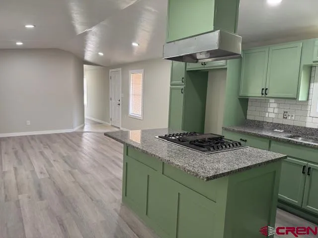 a kitchen with a sink and a stove top oven
