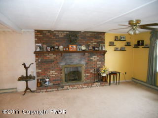 529 Rigby Lane Bushkill, PA 18324 - Photo 3 of 10 a view of a fireplace and table in a room