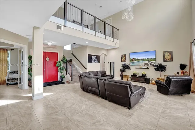 a living room with furniture and kitchen view