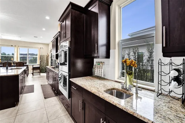 a kitchen with granite countertop a sink and cabinets