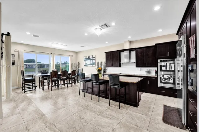 a living room with lots of furniture and kitchen view