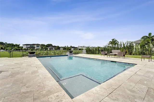 a view of a swimming pool with an outdoor seating