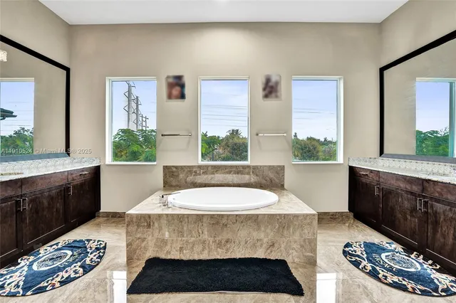 a bathroom with a bathtub a sink and a window