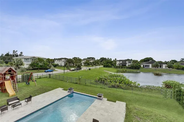 a view of a lake with houses in the back