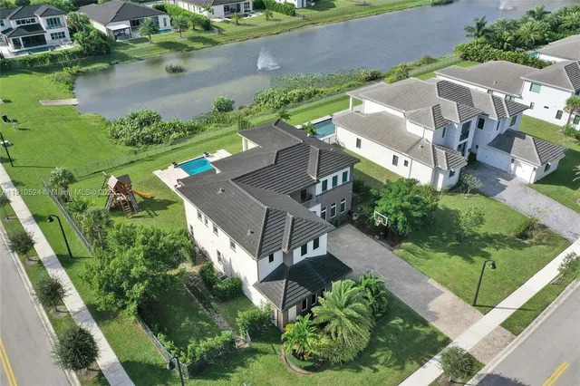 an aerial view of a house with a yard