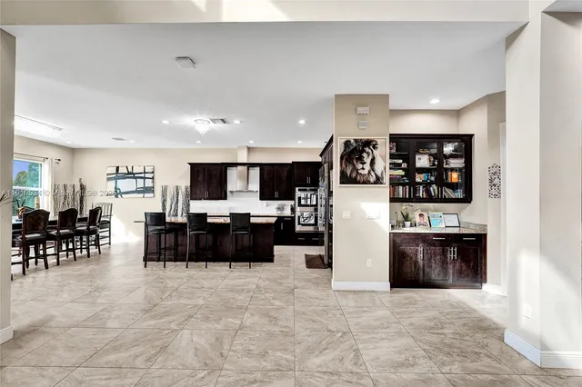 a view of a living room kitchen and stainless steel appliances