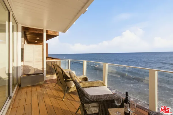 a balcony with chairs and with wooden floor