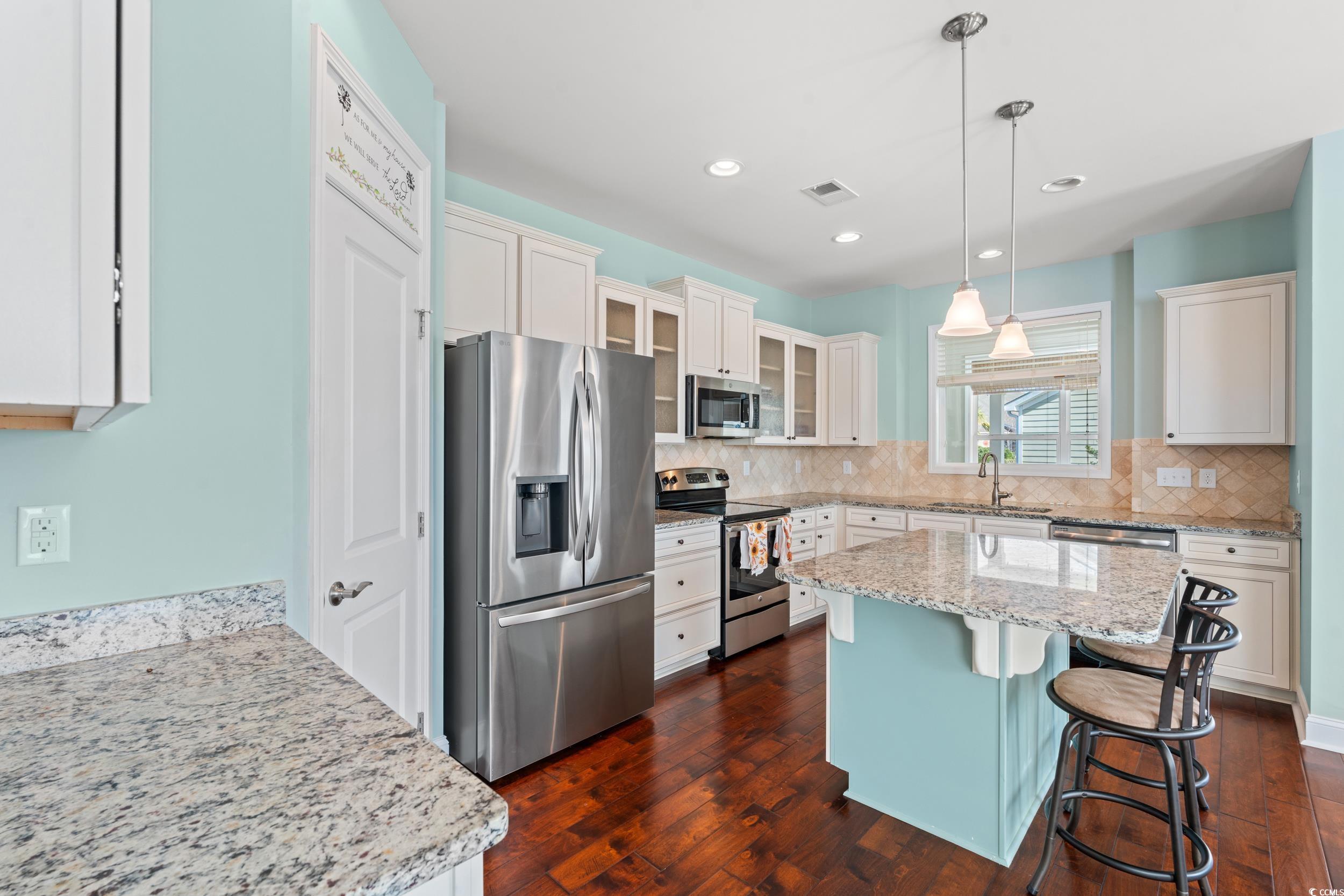 2017 Silver Spring Lane Myrtle Beach, SC 29577 - Photo 13 of 40 Kitchen with decorative light fixtures, dark hardw