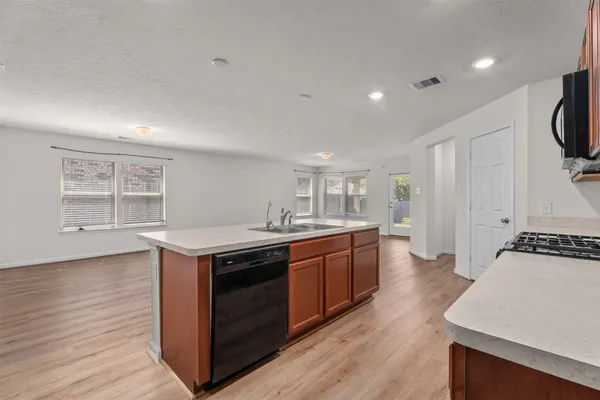 a kitchen with stainless steel appliances granite countertop a stove and a sink