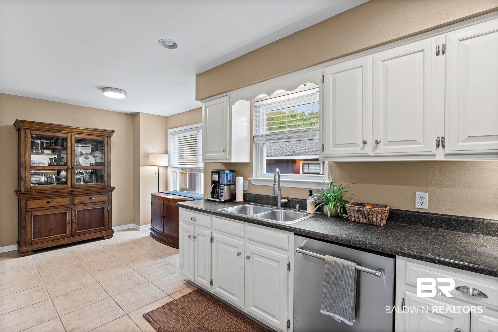 6501 Gas Light Lane South Mobile, AL 36695 - Photo 8 of 23 Kitchen featuring white cabinetry, dark countertops, a double basin stainless steel sink, and a stainless steel dishwasher