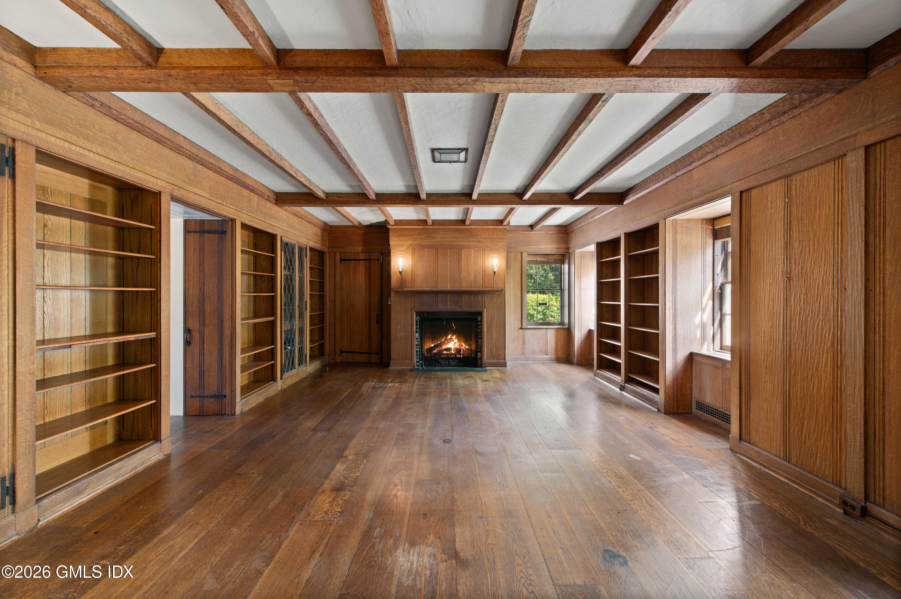 122 Round Hill Road Greenwich, CT 06831 - Photo 12 of 37 a view of an empty room with wooden floor fireplace and a window