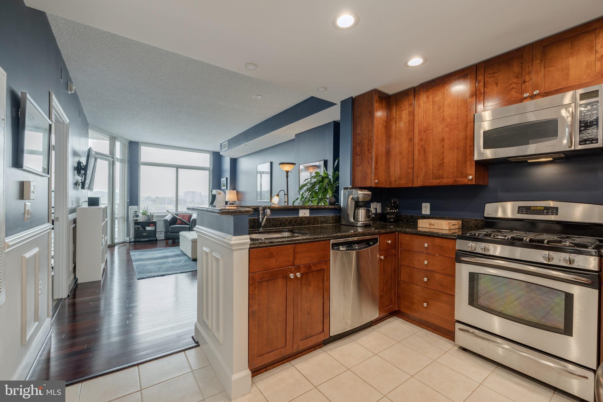 3600 South Glebe Road, Unit 409W Arlington, VA 22202 - Photo 34 of 34 a kitchen with stainless steel appliances granite countertop a stove top oven a sink dishwasher and cabinets