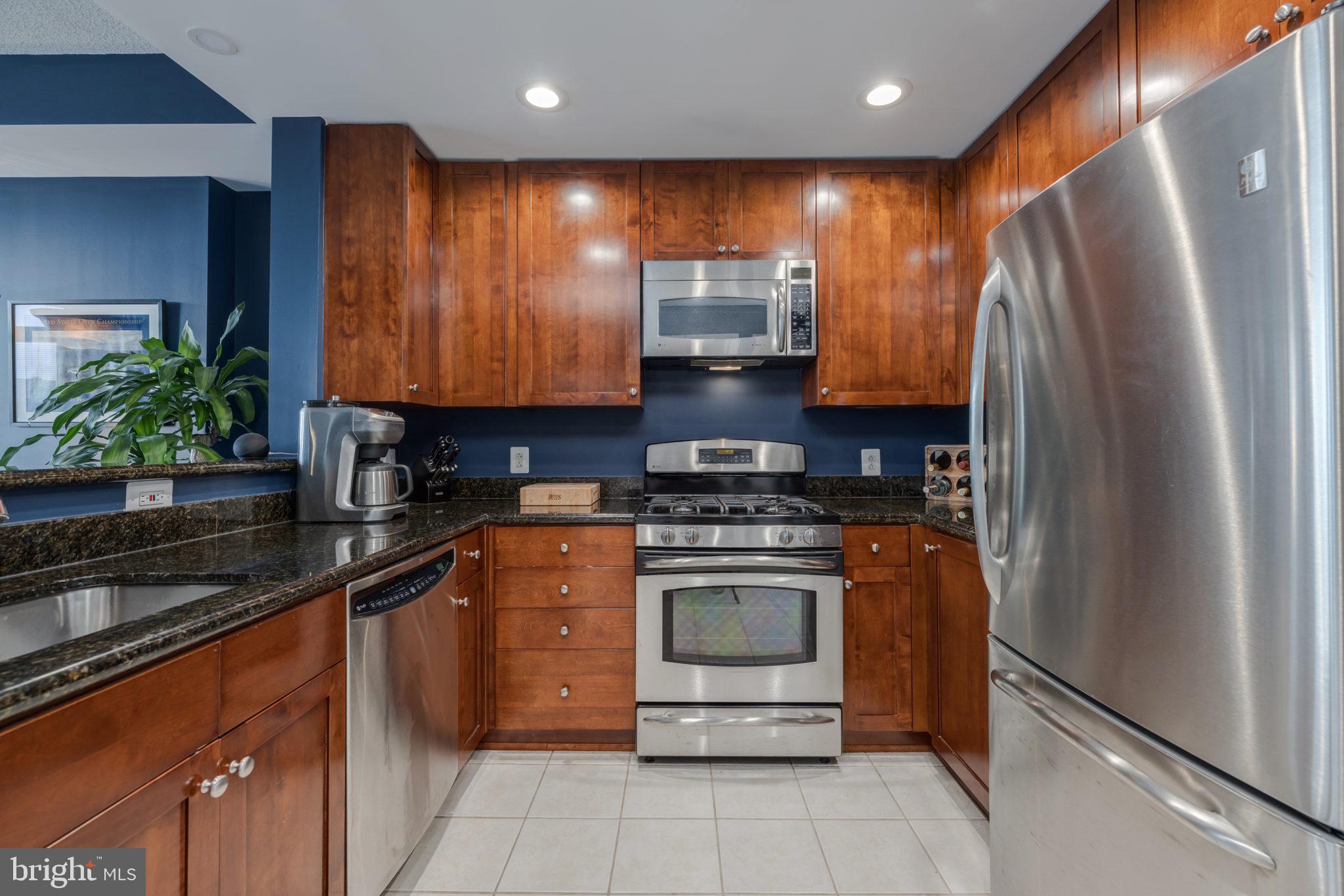 3600 South Glebe Road, Unit 409W Arlington, VA 22202 - Photo 5 of 34 a kitchen with stainless steel appliances granite countertop a refrigerator a stove and a sink