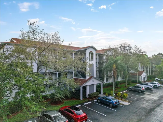 a view of a patio with couches and table and chairs and potted plants