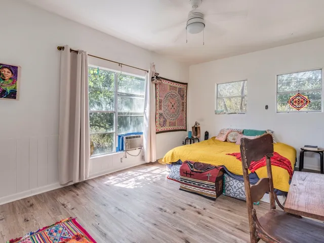 a bed room with furniture and wooden floor