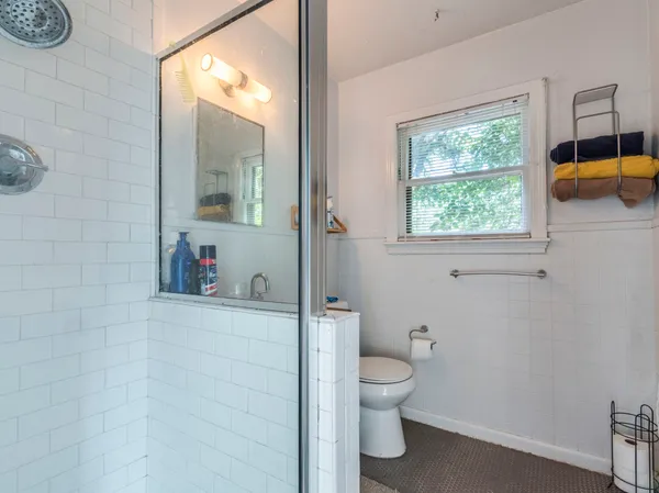 a white toilet sitting next to a bathroom sink