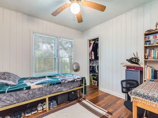 a living room with furniture a flat screen tv and a table