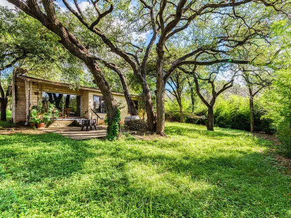 a view of a patio with table and chairs under an umbrella