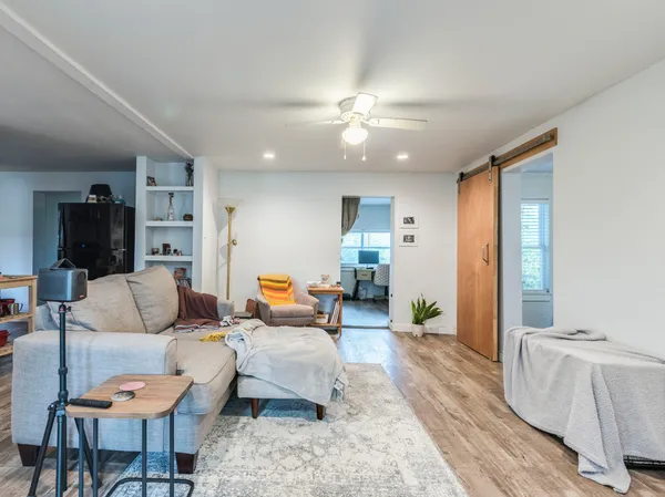 a living room with furniture and a chandelier