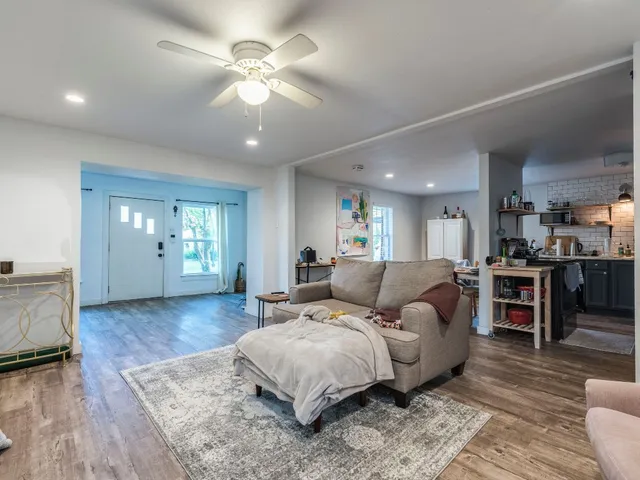 a living room with furniture and wooden floor