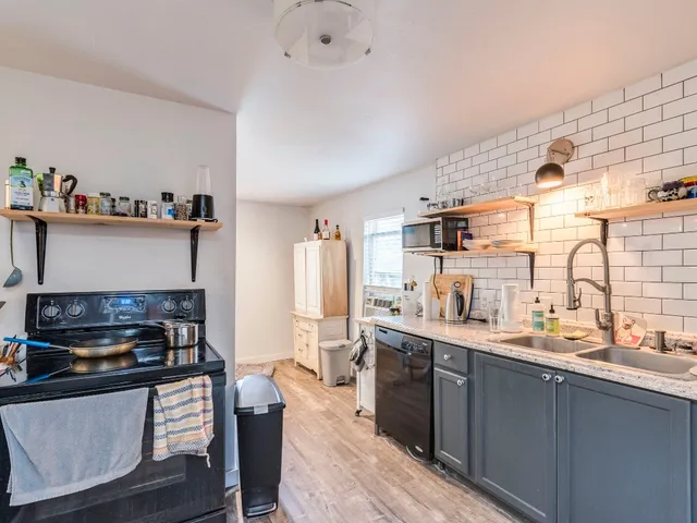 a kitchen with stainless steel appliances granite countertop a stove and cabinets