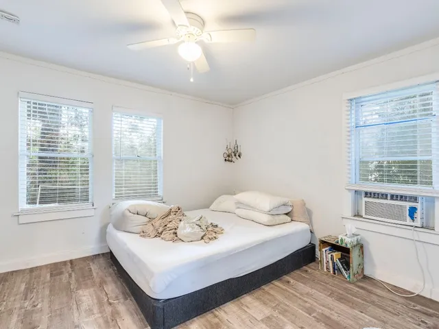 a bedroom with a bed and a window