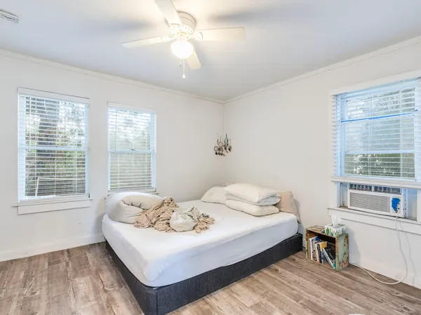 a bedroom with a bed and a window