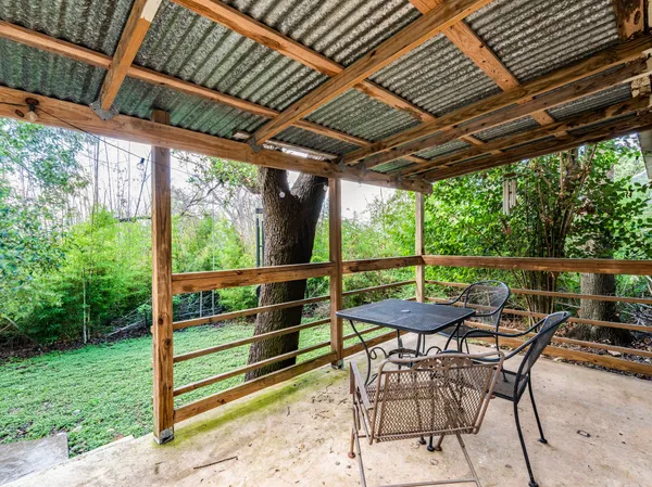 a view of a porch with furniture and backyard
