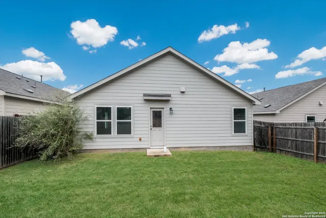 a view of a house with a backyard