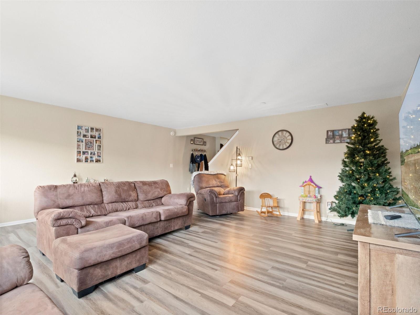 9323 Welby Road Denver, CO 80229 - Photo 12 of 40 a living room with furniture and a christmas tree