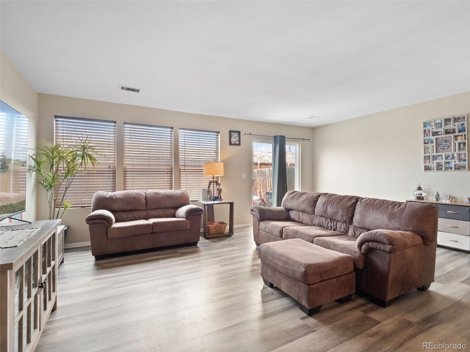 9323 Welby Road Denver, CO 80229 - Photo 14 of 40 a living room with furniture and a large window