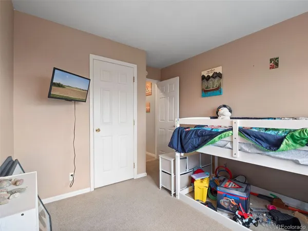 a bedroom with furniture and a potted plant