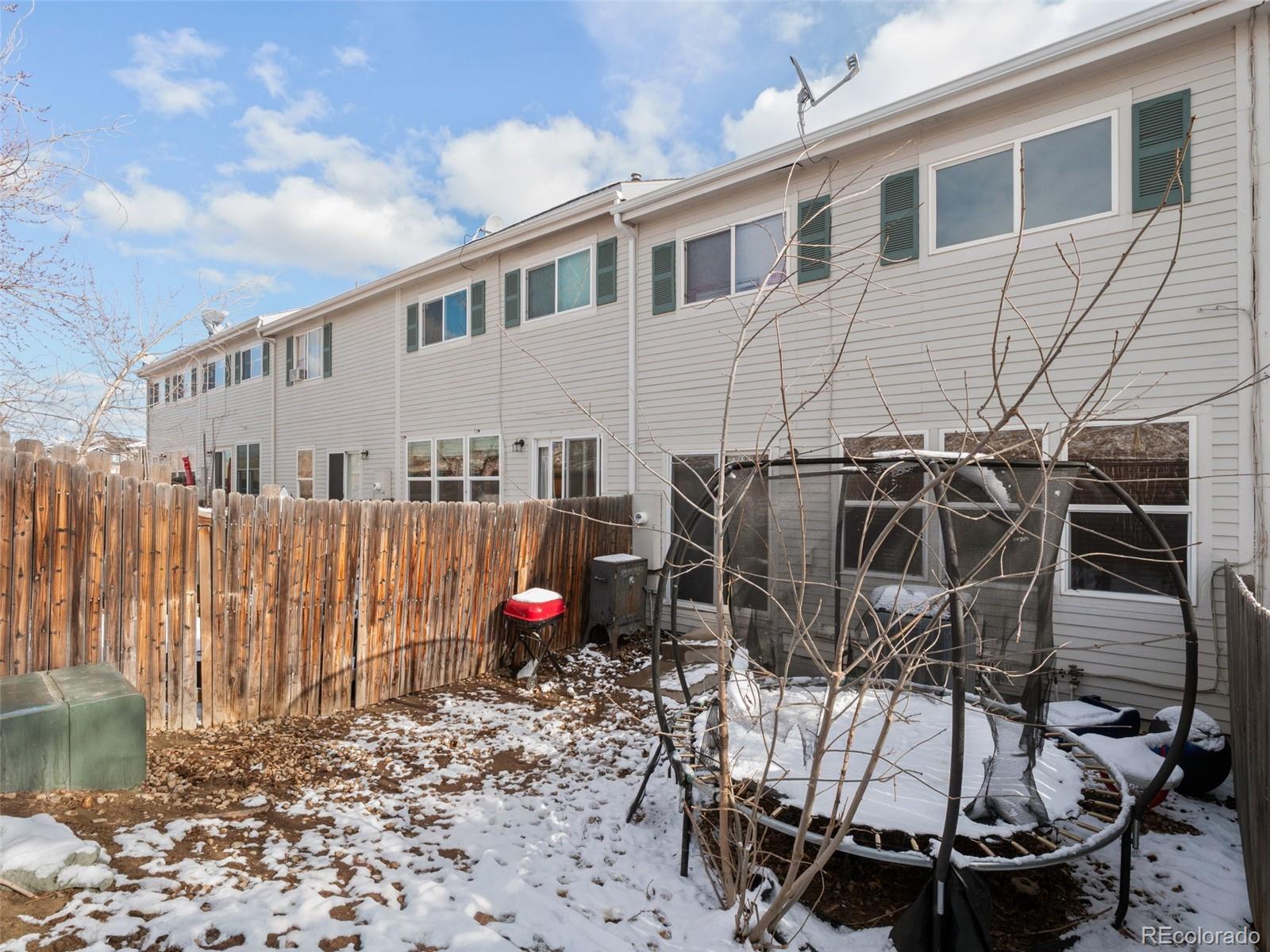 9323 Welby Road Denver, CO 80229 - Photo 28 of 40 a view of a patio with a table and chairs