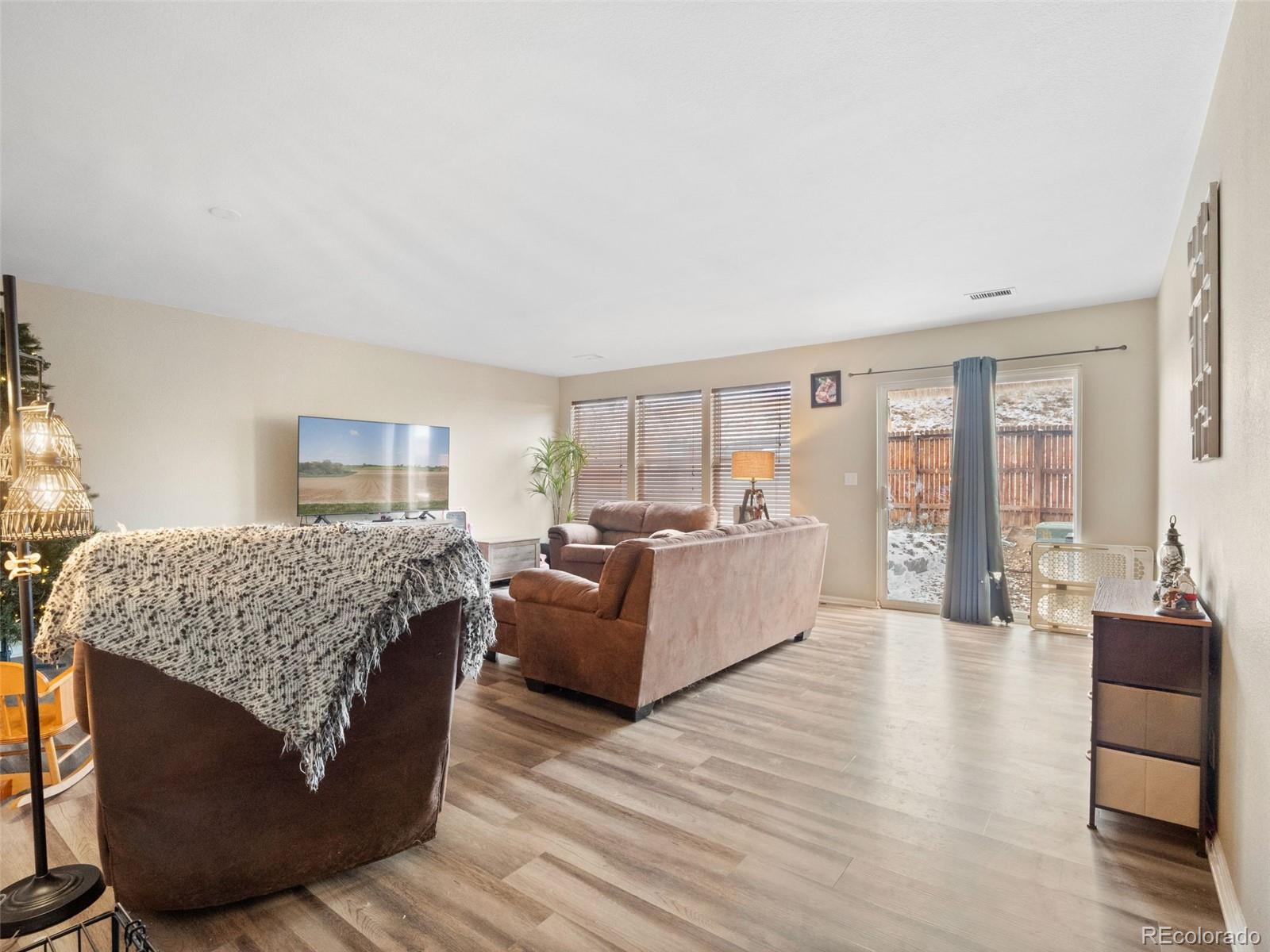 9323 Welby Road Denver, CO 80229 - Photo 33 of 40 a living room with furniture and wooden floor