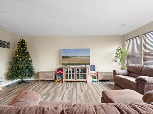 a living room with furniture and a christmas tree
