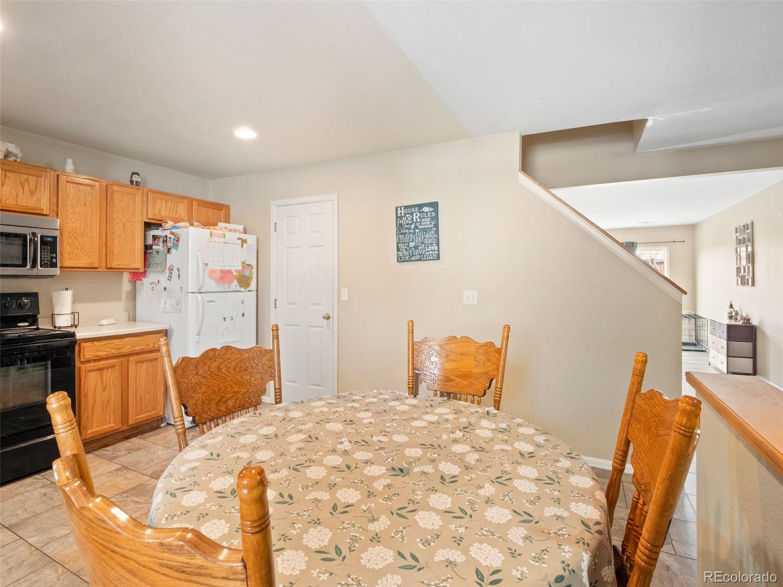 9323 Welby Road Denver, CO 80229 - Photo 36 of 40 a bedroom with a bed and wooden floor