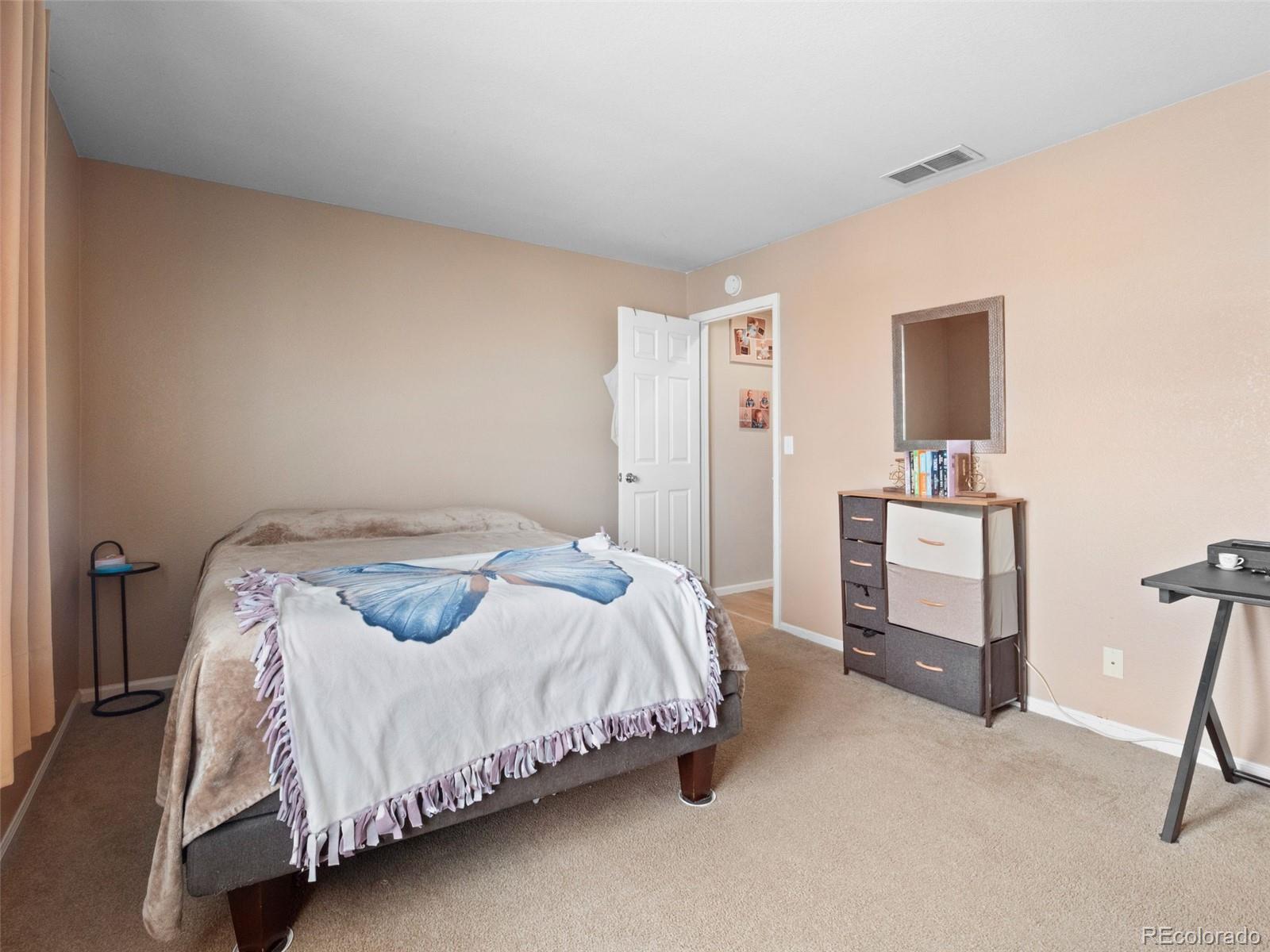 9323 Welby Road Denver, CO 80229 - Photo 39 of 40 a bedroom with a bed and a desk