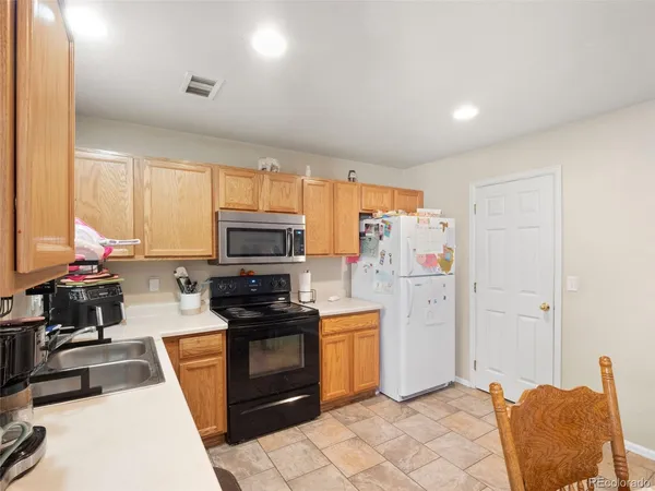 a kitchen with a refrigerator stove and sink