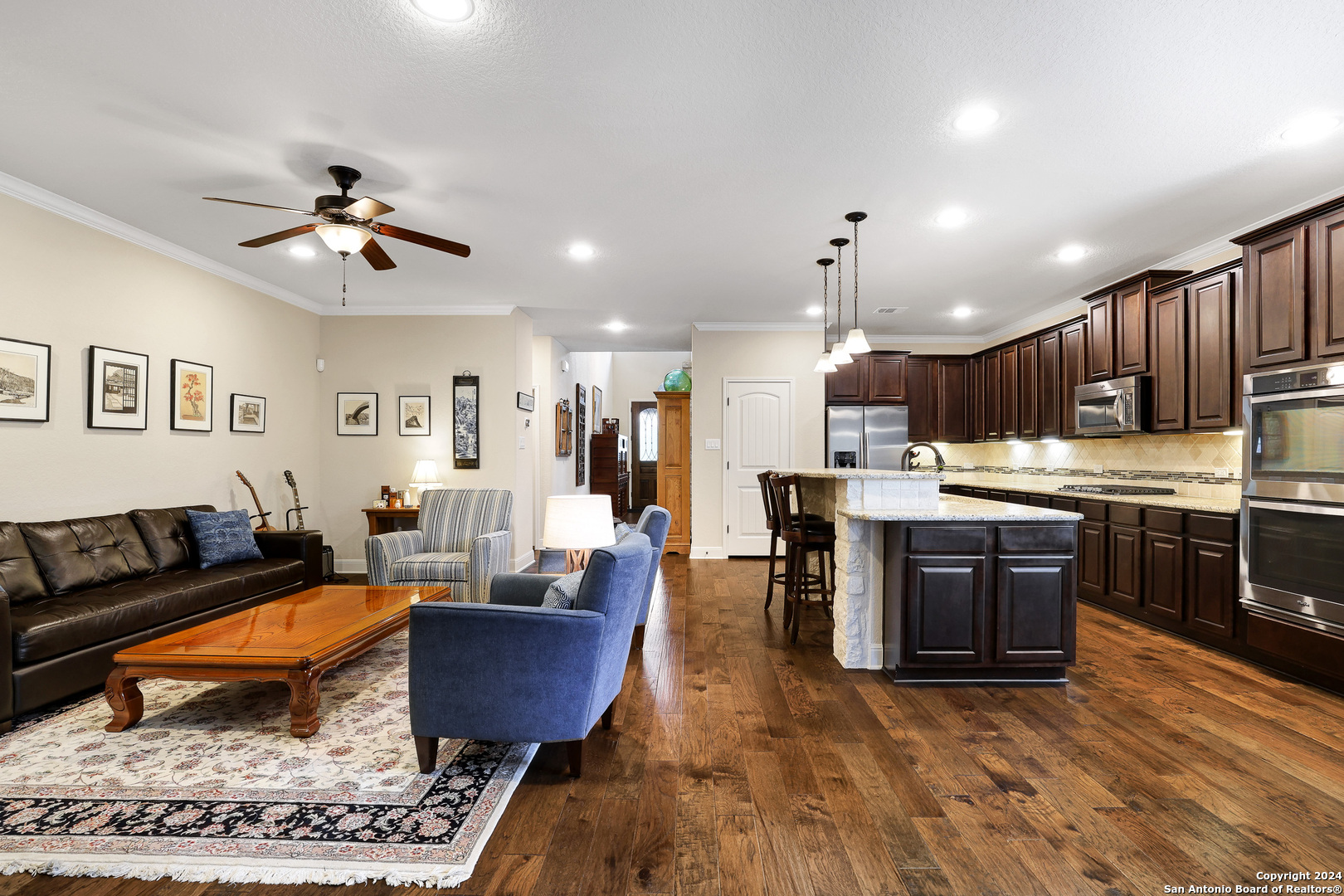 28565 Willis Ranch San Antonio, TX 78260 - Photo 12 of 39 a living room with stainless steel appliances kitchen island granite countertop furniture wooden floor and a view of kitchen