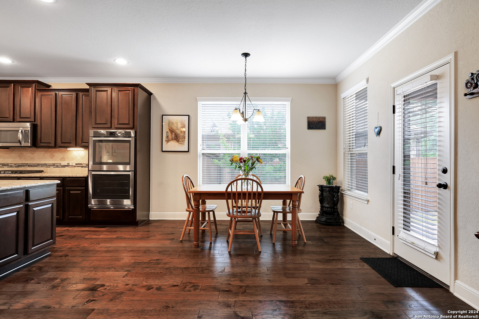 28565 Willis Ranch San Antonio, TX 78260 - Photo 14 of 39 a view of a dining room with furniture window and wooden floor