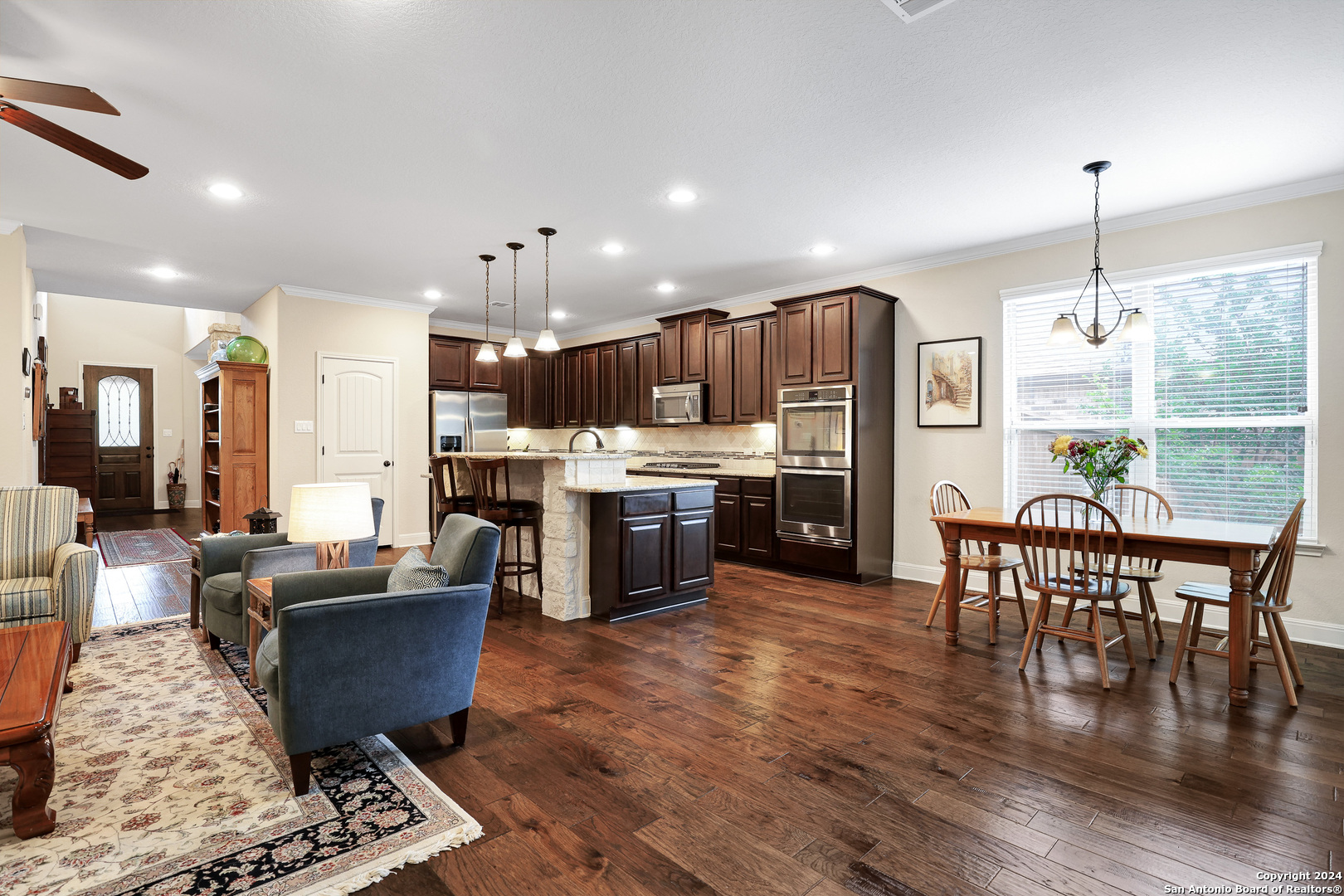 28565 Willis Ranch San Antonio, TX 78260 - Photo 15 of 39 a living room with stainless steel appliances kitchen island granite countertop furniture wooden floor and a kitchen view