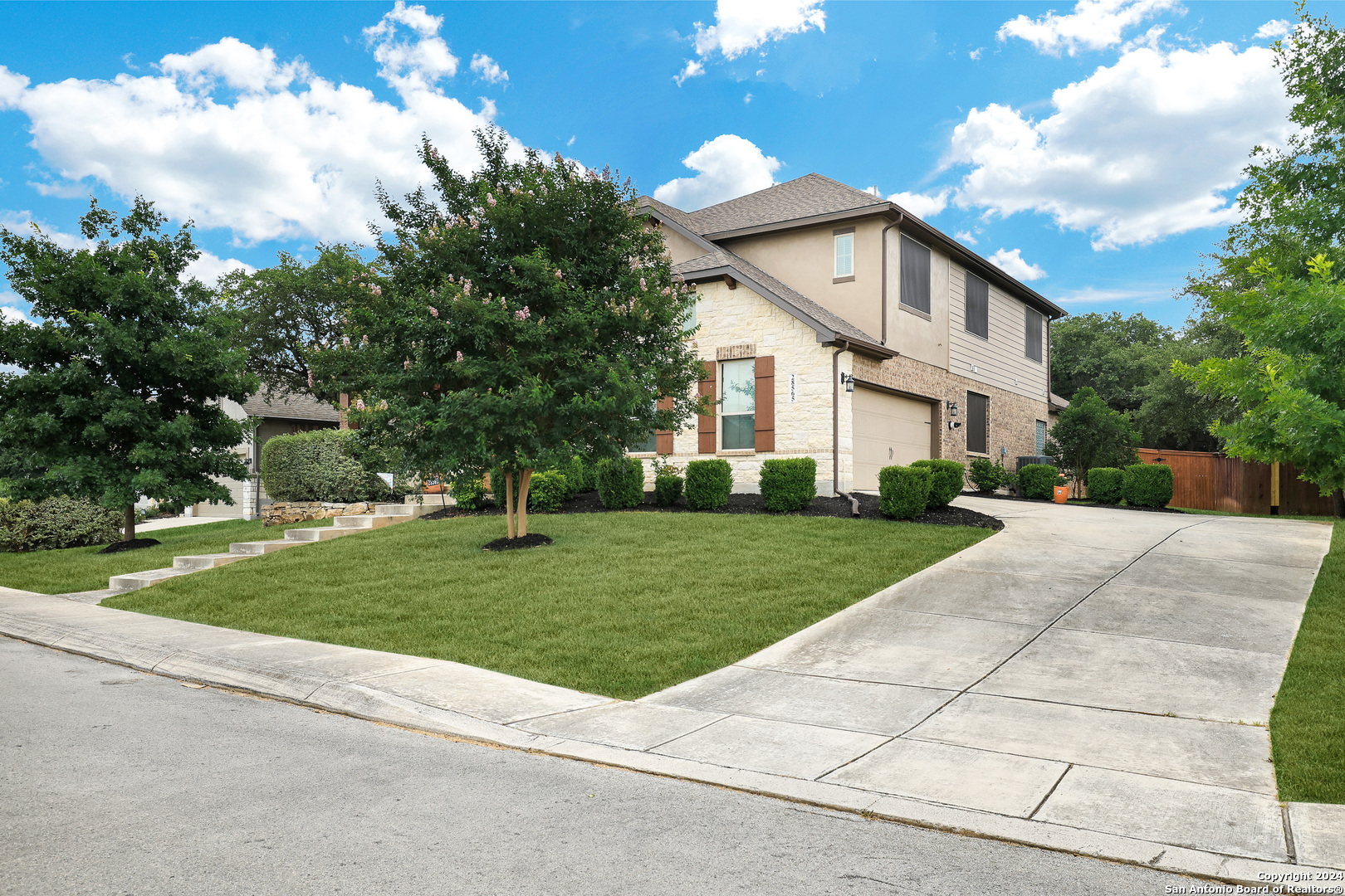 28565 Willis Ranch San Antonio, TX 78260 - Photo 2 of 39 a view of a white house next to a yard with big trees