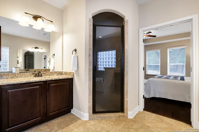 a bathroom with a double vanity sink and a mirror