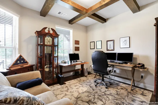 a livingroom with workspace and a couch