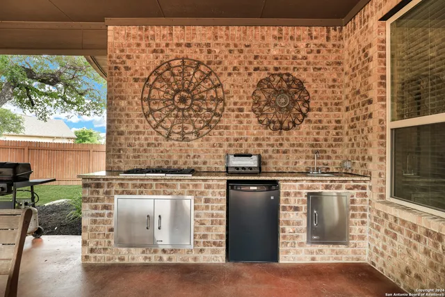 a front view of a house with a garden and trees